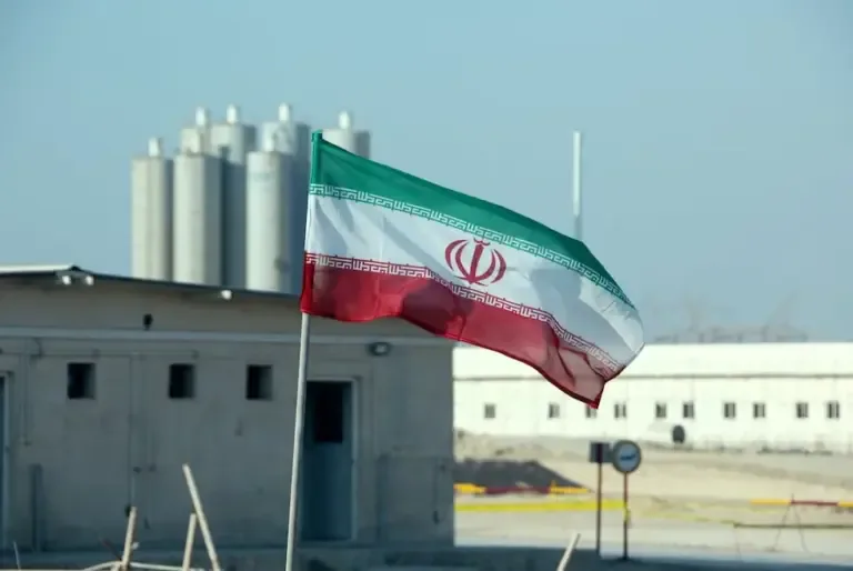 This photo from November 10, 2019, shows an Iranian flag at the Bushehr nuclear power plant during the official ceremony to start work on a second reactor. (Photo by ATTA KENARE / AFP).
