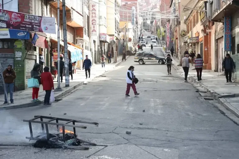 People walk along a closed road during a day of blockades by transporters in La Paz, Bolivia. (EFE/ Luis Gandarillas).