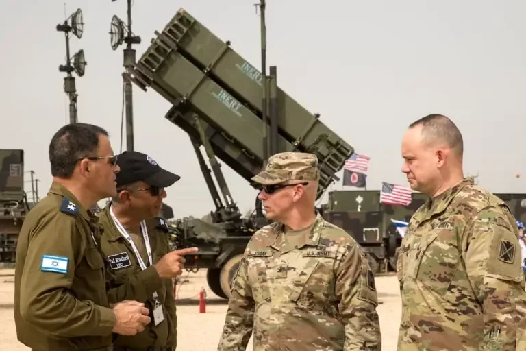 U.S. and Israeli army officers talk in front of a U.S. Patriot missile defense system on March 8, 2018. (Photo by JACK GUEZ / AFP).