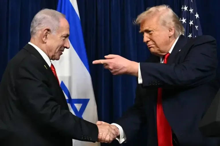 U.S. President Donald Trump and Israeli Prime Minister Benjamin Netanyahu shake hands at Mar-a-Lago, Palm Beach, Florida, December 29, 2025. (Photo by Jim WATSON / AFP).