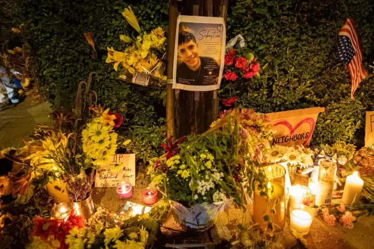 People light candles and leave flowers at the site where ICE federal agents shot and killed a Colombian immigrant in Biddeford, Maine, United States, July 13, 2026. (EFE/EPA/TROY R. BENNETT).