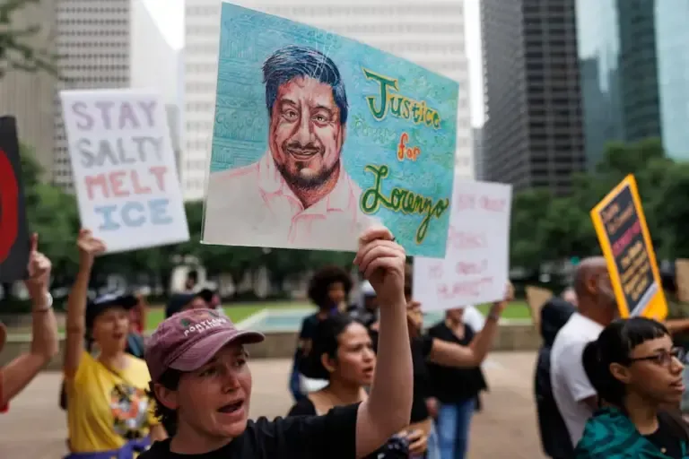 Protesters hold signs during a protest against ICE for the murder of Mexican migrant Lorenzo Salgado Araujo, in front of Houston City Hall, Texas, July 14, 2026. (Photo by Mark Felix / AFP).