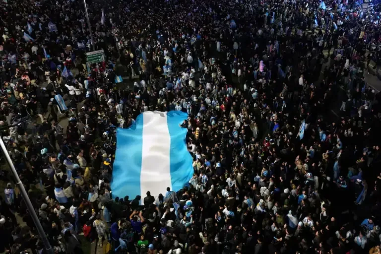 This aerial view shows Argentine fans waving an Argentine flag as they celebrate on Corrientes Avenue in Buenos Aires in the early hours of July 12, 2026, after their team’s victory in the quarterfinals of the 2026 FIFA World Cup against Switzerland. (Photo by Luis ROBAYO / AFP)