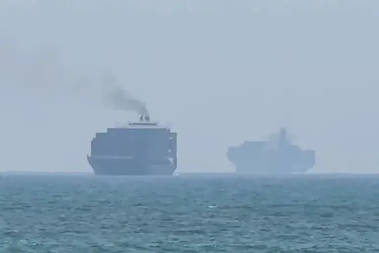 Cargo ships anchored near the Strait of Hormuz, off the eastern coast of the United Arab Emirates in Khor Fakkan. (Photo by AFPTV / AFP).