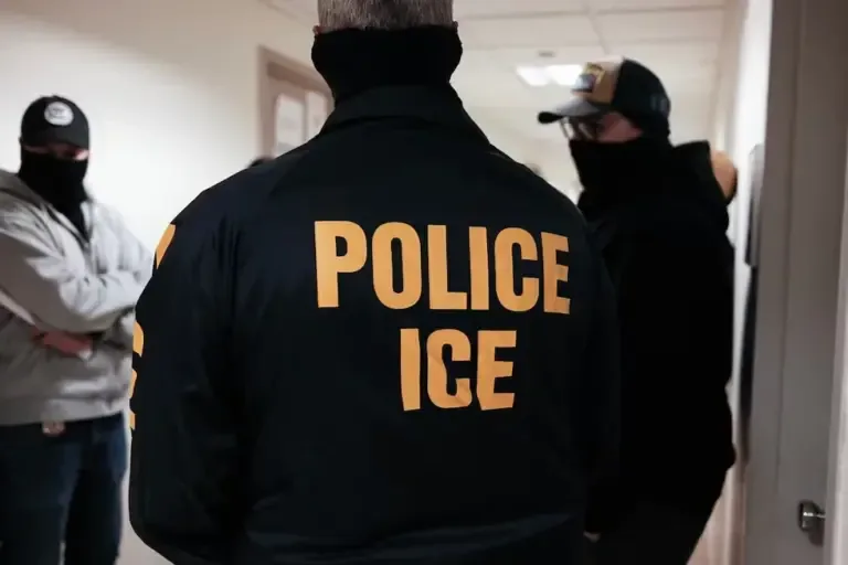 Masked federal agents wearing ICE jackets stand in a hallway of the New York Immigration Court at the Jacob K. Javitz Federal Building, March 17, 2026. (CHARLY TRIBALLEAU / AFP)
