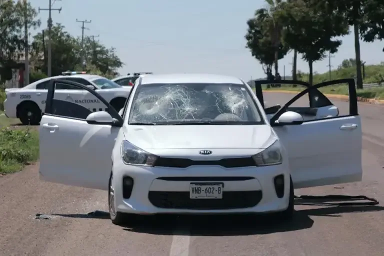 A car riddled with bullets after a shootout that left two soldiers injured, one of whom later died at the Culiacán hospital, on September 9, 2024. (Photo by Iván MEDINA / AFP).