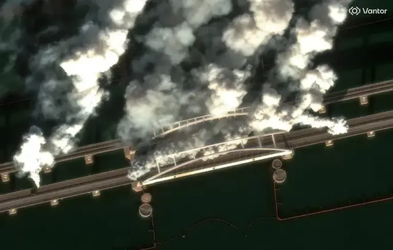 This satellite image, courtesy of Vantor, taken on June 22, 2026, shows smoke on the Crimea Bridge, also called the Kerch Strait Bridge. (Satellite image ©2026 Vantor / AFP).