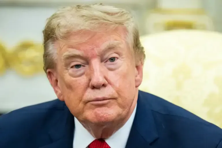 U.S. President Donald Trump watches as he meets with lifeguard Ryder Williams in the Oval Office of the White House on August 17, 2026. (Photo by Jim Watson / AFP).