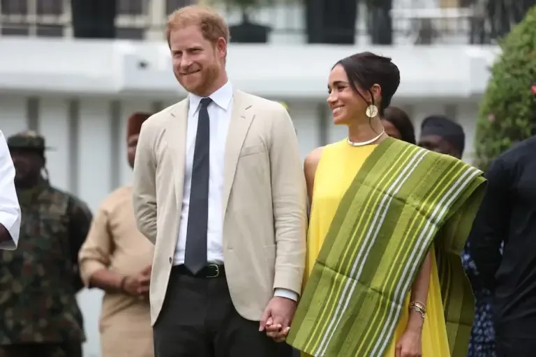 Prince Harry and his wife Meghan react as the governor of Lagos state, Babajide Sanwo-Olu, delivers a speech on May 12, 2024, during their visit to Nigeria. (Photo by Kola SULAIMON / AFP).