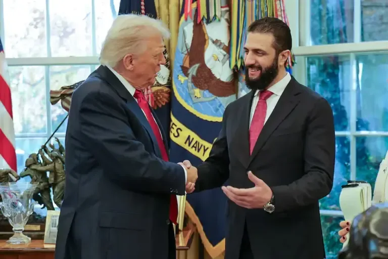 U.S. President Donald Trump (left) shaking hands with Syrian President Ahmed al Sharaa at the White House. (Photo: SANA / AFP).