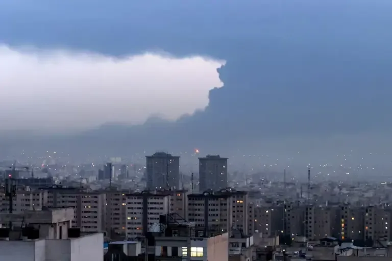 Smoke from the fire at the Tehran oil refinery covers the city skyline on March 8, 2026, after Israeli bombings against Iran. (Photo by ATTA KENARE / AFP).