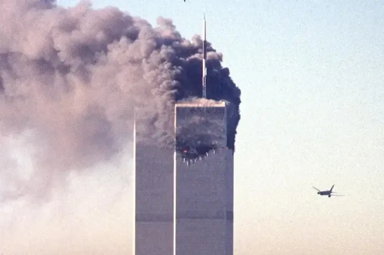 United Airlines Flight 175 approaches the south tower of the World Trade Center as smoke rises from the north tower in lower Manhattan, New York, on September 11, 2001. (Photo by SETH MCALLISTER / AFP).