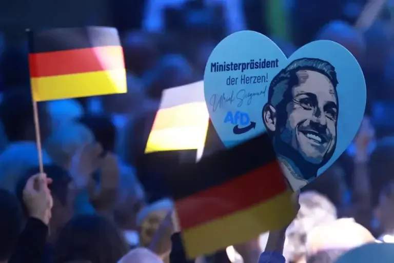 German flags and a heart-shaped banner with the image of Ulrich Siegmund during the final campaign event of the AfD party in Magdeburg, Germany, on September 5, 2026. (EFE/EPA/CLEMENS BILAN).