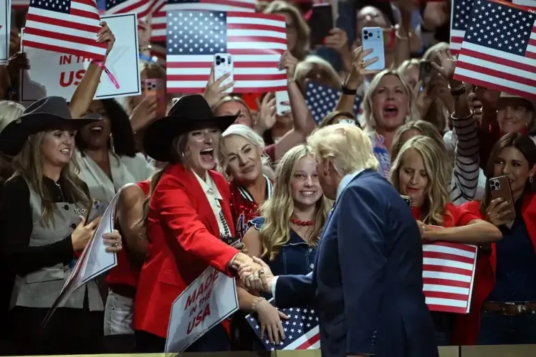 U.S. President Donald Trump greets attendees upon arrival to speak during the Republican National Midterm Election Convention at the American Airlines Center in Dallas, Texas. (Photo by RONALDO SCHEMIDT / AFP).