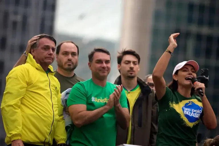 Michelle Bolsonaro speaks alongside her husband, former president of Brazil Jair Bolsonaro (L), and their children Carlos (2-L), Flavio (C), and Renan during a rally on Avenida Paulista in São Paulo, Brazil, April 6, 2025. (Photo by Miguel SCHINCARIOL / AFP).