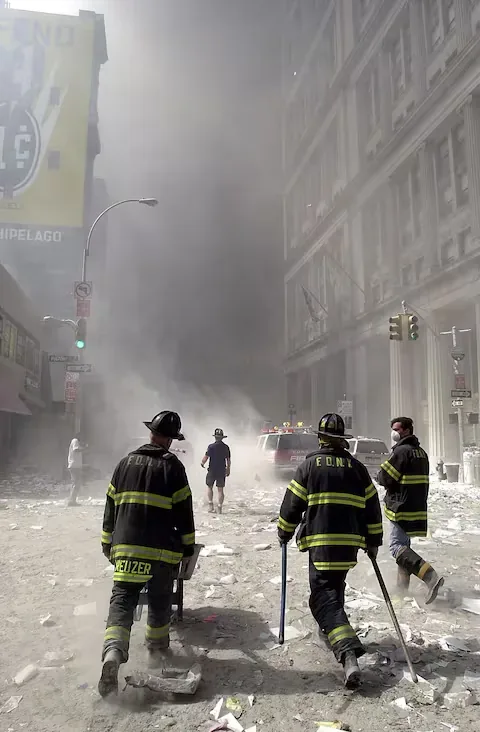 Firefighters head south from Broadway and Fulton Street, a few blocks from the World Trade Center site, crossing debris and remains after the collapse of one of the World Trade Center towers on September 11, 2001 in New York. (Photo: AFP)