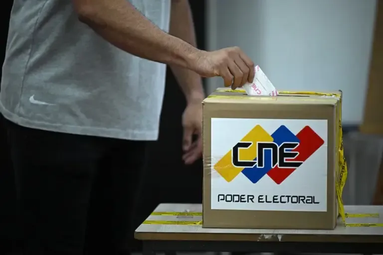 A man casts his vote at a polling station during regional and legislative elections in Venezuela on May 25, 2025. (Photo by Federico PARRA / AFP).